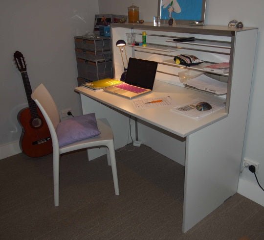 Plankwall white reception desk used as a study desk in a bedroom setting