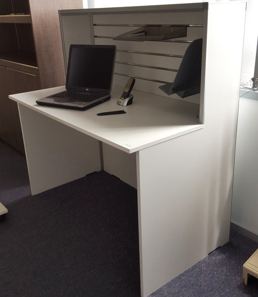 Small reception desk shown in a showroom setting