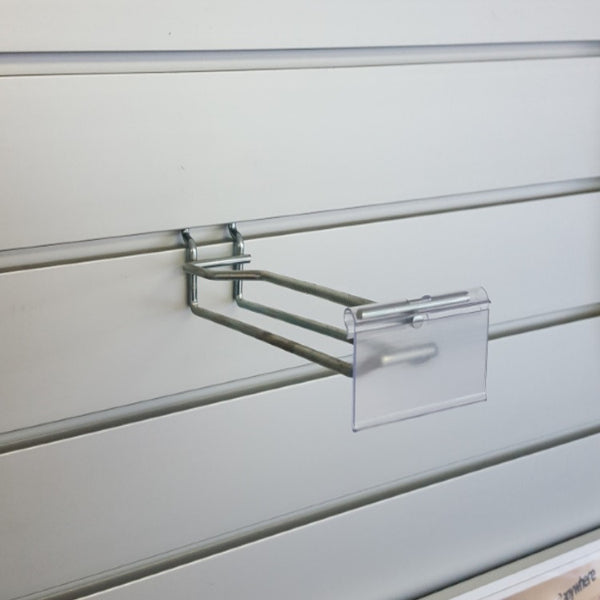Plankwall flip ticket double prong hook holding heavier ticketed merchandise with pricing visible on slatwall retail display wall