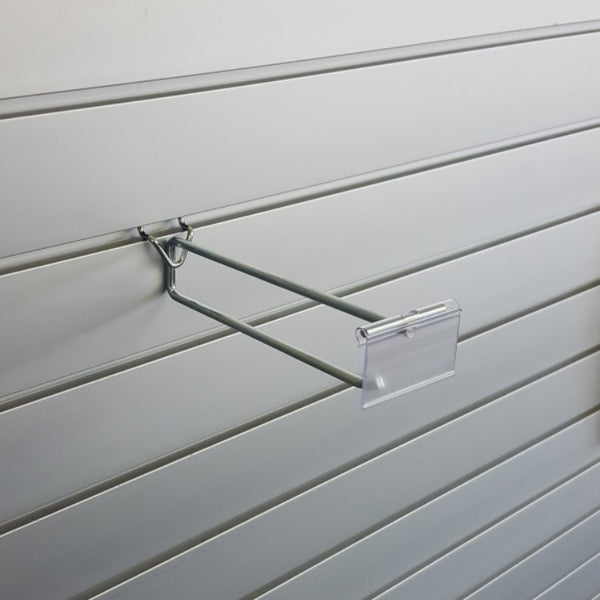 Plankwall flip ticket single prong hook displaying ticketed impulse items with pricing visible on slatwall retail display wall