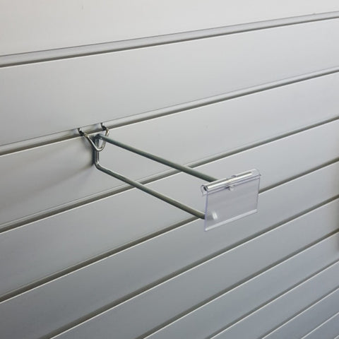 Plankwall flip ticket single prong hook displaying ticketed impulse items with pricing visible on slatwall retail display wall