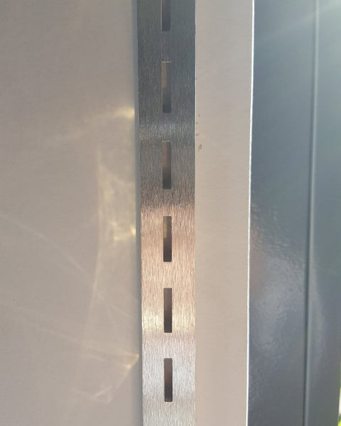 Photo of Plankwall single slotted wall channel 19xmmx12mm against a retail display wall in natural aluminium