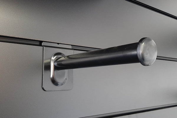 close-up of Plankwall black straight arm integrated into a modular slatwall system for organised merchandising.