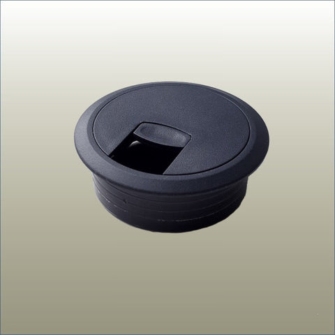 A black circular cable port with a removable center insert, designed for table legs.