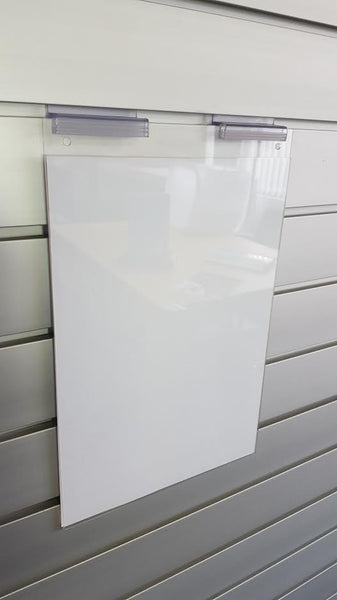 Clear signholder with a piece of white paper wall mounted on a aluminium slatwall panel using Plankwall slatwall supergrip Clip