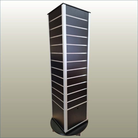 shown here is a four-sided rotating slatwall display stand in black with plinth and hidden storage on a gold background
