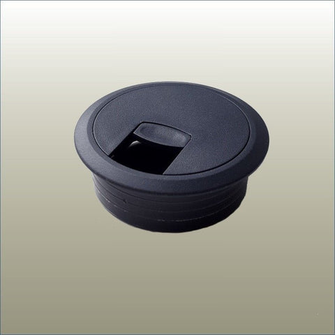 A black circular cable port with a removable center insert, designed for table legs.
