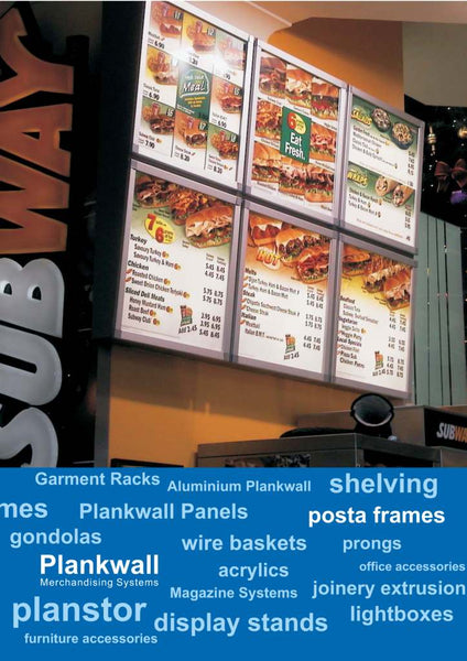 Plankwall aluminium snap frames displaying menus and price lists in a Subway store, with a blue advertising panel below listing PLankwall products. 