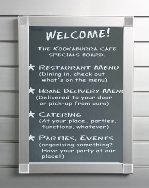 A  Plankwall aluminium snap frame with displaying a welcome sign at a cafe mounted on a slatwall.