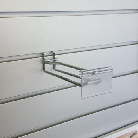 Plankwall flip ticket double prong hook holding heavier ticketed merchandise with pricing visible on slatwall retail display wall