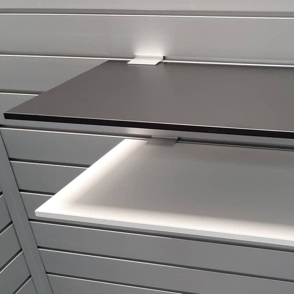 close up of Plankwall 9mm melamine shelves in black and white with shelf brackets on a Plankwall slatwall.