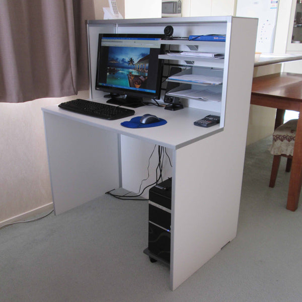 Small white reception desk in an office setting