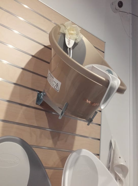 retail display example of adjustable tilted metal bracket for slatwall presentation found in a baby shop